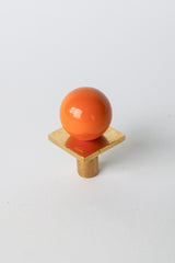 Vibrant orange and brass square gumball drawer pull with glossy finish, perfect for modern cabinet hardware, dresser knobs, and colorful furniture updates. Great for kitchens, bathrooms, or kids’ rooms—this bold, retro-inspired knob adds playful, midcentury modern charm and warmth.