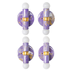 A collection of four lavender marbled Thalia sconces showing the natural variation in each finish. Each piece shares the same soft purple palette and brass detailing, but the marbling pattern makes every sconce feel unique. Together they highlight the charm of handmade variation and the playful, collected look these sconces bring to a space.