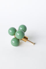 Pastel Vista Green and brass oversized ball cube drawer pull shown on a white background; designed with five lacquered blue spheres arranged in a cube formation on a polished brass base, perfect for high-end interior hardware styling.