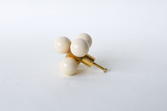 Oversized Ball-Cube Knob in a soft cream finish, featuring five powder-coated spheres mounted on a brass cube base. This 2.75-inch-wide, handmade drawer pull offers a luxurious and customizable touch, available in 30 curated colors to elevate cabinets, dressers, or drawers with an artistic flair.