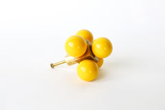 Oversized Ball-Cube Knob in vibrant yellow, featuring five glossy, powder-coated spheres on a brass cube base. This 2.75-inch-wide, handmade drawer pull is customizable in 30 curated colors, adding a bold and modern statement to cabinets, dressers, or drawers.