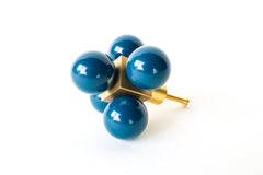 Oversized Ball-Cube Knob in Lagoon, featuring five glossy, powder-coated spheres on a brass cube base. This 2.75-inch-wide, handmade drawer pull is available in 30 curated colors, making it a stylish and customizable addition to cabinets, dressers, or drawers for a bold, modern touch.