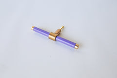 Pastel Purple and brass modern drawer pull.  Add color to cabinets with brass accents with the Piety drawer pulls by sazerac stitches.  Available in over 30 colors with the option to customize. Center mount installation drawer pull with color and brass accents.  Sophisticated colorful bathroom, dresser, vanity, or desk drawer pull.  