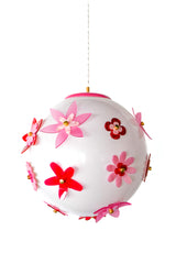 Hanging shot of the Pink and Red Blossom Gumball Chandelier with a white globe pendant shade covered in dimensional acrylic flowers in pink and red with brass centers, a whimsical flower power ceiling light that fits maximalist decor, playful modern homes, kids bedrooms, and colorful entryways.
