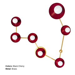 Pisces star sign wall light in deep black cherry red and brass, constellation style sconce with round powder coated steel discs and glowing white globe bulbs, modern sculptural statement fixture with mid century modern vibes and artsy maximalist energy, perfect for a pretty powder room, feminine bathroom lighting, bold eclectic home decor, colorful designer bathroom vanity sconce, astrology inspired wall fixture for personality filled interiors