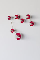 Pisces star sign wall light in deep black cherry red and chrome, constellation style sconce with round powder coated steel discs and glowing white globe bulbs, modern sculptural statement fixture with mid century modern vibes and artsy maximalist energy, perfect for a pretty powder room, feminine bathroom lighting, bold eclectic home decor, colorful designer bathroom vanity sconce, astrology inspired wall fixture for personality filled interiors