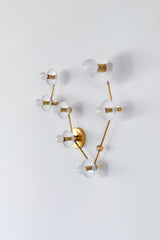 Pisces constellation wall sconce in glossy white with warm brass hardware, featuring powder coated steel disc backplates and a branching star map design with multiple globe bulbs, a celestial zodiac light fixture that works as a bathroom vanity sconce, pretty powder room statement lighting, bedroom wall light, or hallway accent, combining mid century modern brass styling with astrology inspired decor for design lovers who want an artful, sculptural fixture that feels elevated, feminine, and a little bit mag