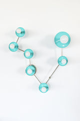 Pisces zodiac constellation wall sconce in Poolside aqua blue with chrome hardware, featuring glossy powder-coated steel disc shades and frosted globe bulbs arranged like a star map; modern celestial lighting for a playful bathroom vanity, powder room accent, eclectic bedroom, kids room decor, or maximalist interior design.