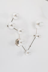 Pisces zodiac constellation wall sconce in glossy white with polished chrome hardware, featuring multiple round powder coated steel discs on branching arms with small globe bulbs, a sculptural celestial statement light for a modern bathroom vanity, powder room lighting, hallway or bedroom wall, mid century modern inspired design with an artful star sign layout for astrology lovers, maximalist interiors, and eclectic homes that want a clean white fixture with personality and gallery style impact.