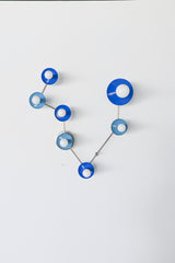 Pisces zodiac constellation wall sconce in Mediterranean blue and hydrangea blue with polished chrome arms and hardware, featuring powder-coated steel disc backers and globe bulbs arranged like a star map; playful modern wall lighting for a statement bathroom vanity, powder room, hallway, or bedroom, ideal for maximalist decor, eclectic interiors, coastal modern, and bold color lovers who want a star-sign light fixture with personality.