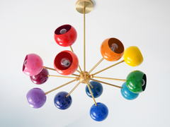 Rainbow sputnik chandelier with glossy multicolor globe shades and warm brass arms, modern mid century ceiling light with red, pink, orange, yellow, green, teal, blue, and purple orbs, playful maximalist statement lighting for a kids bedroom, nursery, playroom, or colorful dining room, contemporary atomic starburst chandelier