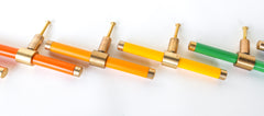 Piety knobs in a rainbow layout. orange & brass, mustard & brass, yellow & brass hardware knobs. Colorful cabinet knobs for furniture makeovers, kitchens, and bathroom upgrades and more. Colorful knobs are especially fun in kid spaces or artistic art spaces.