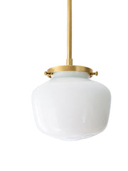 There's a particular magic when brass hardware meets schoolhouse glass—a conversation between collected vintage and intentional design. The petite dome of this shade has presence despite its compact size, mounted on a warm brass rod that catches light like jewelry. Imagine a hallway lined with these, or a powder room where every detail matters. The schoolhouse form, with its structured silhouette and architectural presence, becomes a collector's detail—the kind of fixture that makes visitors pause and ask w