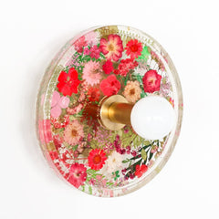 red floral wall sconce with brass hardware. uses real dried flowers and pressed leaves.