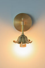 Brass floral wall sconce with cast brass detailing.  Modern take on traditional style brass light fixtures that retails old-world European charm with the finial and brass flower. Octavia wall sconce made by Sazerac Stitches in New Orleans
