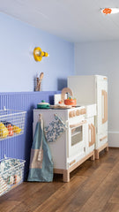 This colorful kids’ play kitchen features the Small Thalia Sconce in yellow by Sazerac Stitches, paired with purple-blue walls and playful details. Perfect inspiration for colorful playrooms, creative kids’ spaces, and nursery design. See more colorful kids’ interiors in our blog: 10 Reasons Kids Need Color in Their Interiors.