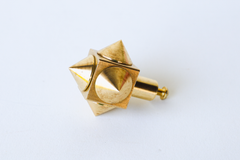 A cabinet knob with some attitude. The Spike Cube Knob is a brass cube with cone-shaped spikes projecting from its faces, set on a short cylindrical post with a screw for mounting. The geometry reads Art Deco with a little punk edge, and the warm brass has soft, natural-looking variation. A fun pick for a dresser, vanity, kitchen island or any piece that needs a conversation-starting pull.