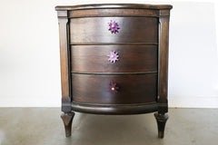 Wood nightstand with purple splat knobs attached