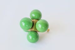 Bright grass green and brass statement knob that has balls on a centered cube.  Geometric, playful, and colorful oversized knob that will make a statement on any piece of furniture or cabinet.