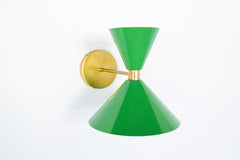 Bright grass green and brass mid century modern style cone-shaped wall sconce.  Designed and made in New Orleans.  Bright green modern wall sconce that can be used in bedrooms, bathrooms, and more.  Fun and colorful lighting.