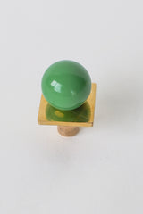 Spring Green and brass Square Gumball Knob from Sazerac Stitches, featuring a glossy pastel green powder-coated steel orb atop a square raw brass base. Handmade in New Orleans, this modern cabinet hardware adds a cheerful pop of color to kitchen drawers, dressers, or nursery furniture. Part of the customizable Gumball Collection.