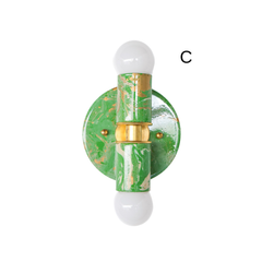 The spring green, cream, and gold Thalia sconce is a colorful, hand-marbled wall light designed to make even the smallest space feel more special. Its cheerful palette and glossy finish bring energy to bathroom walls, powder rooms, kids’ baths, and hallways, while the marbled pattern gives each piece a one-of-a-kind look. This sconce is a great choice for anyone searching for unique bathroom sconces, eclectic wall lighting, colorful vanity lights, or statement lighting for a maximalist interior.