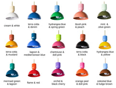 The color-blocked Taeuber pendant, where the sculptural cup top and domed shade come in two different powder-coat colors for a custom, high-personality look. This chart shows just some of the possible pairings, from cream and white to flame and red, orchid and black cherry, chartreuse and doll pink, and mermaid green and lagoon. Each hangs from a warm brass stem, a playful, design-forward way to bring real color to a kitchen island, breakfast nook, bar, or entry. Mix jewel tones, clash brights, or keep