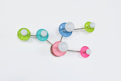 Sazerac Stitches Taurus sconce, a modern celestial wall sconce designed like the Taurus star pattern with multicolor powder-coated discs and white globe bulbs. Perfect for astrology lovers and design-forward interiors, from a colorful bathroom vanity wall to an eclectic gallery wall moment.