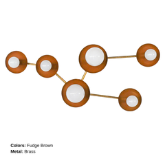 Fudge and brass Taurus sconce with white globe bulbs, designed to mimic the stars of the Taurus constellation. This modern statement wall light is perfect for a warm neutral bedroom, cozy living room, stylish hallway, or sophisticated entryway.