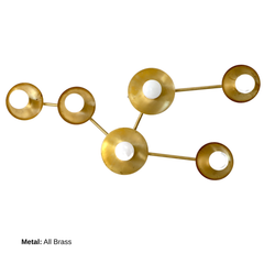 Mid-century modern raw brass constellation wall sconce inspired by Taurus, featuring multiple star discs connected in a clean, geometric pattern. A statement wall light for contemporary interiors, eclectic homes, and modern design spaces. Handmade to order in New Orleans by Sazerac Stitches. Ideal for bedrooms, foyers, hallways, and feature walls.