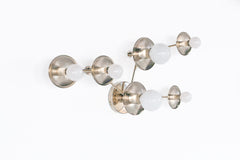 Sculptural Taurus constellation sconce in chrome with layered disc stars and bright globe bulbs, reading like modern wall art. Sleek, reflective metal adds a contemporary, minimalist vibe. Made to order by Sazerac Stitches, New Orleans. Use as hallway lighting, staircase statement lighting, or above a console in an entryway.