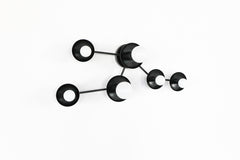 Mid-century modern black constellation wall sconce inspired by Taurus, featuring multiple star discs connected in a clean, geometric pattern. A statement wall light for contemporary interiors, eclectic homes, and modern design spaces. Handmade to order in New Orleans by Sazerac Stitches. Ideal for bedrooms, foyers, hallways, and feature walls.