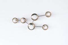 Chrome Taurus constellation wall sconce with small and large “star” discs connected by sleek chrome arms, creating a modern celestial light sculpture. Made to order in New Orleans by Sazerac Stitches. Statement lighting for an entryway, hallway, staircase wall, or bedroom accent wall. Mid-century modern, minimalist, space-inspired wall light.