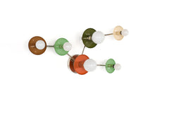 Taurus wall fixture in earthy tones with chrome arms, featuring brown, mint, olive, cream, and terracotta circular discs with globe bulbs. A sculptural constellation-inspired light for eclectic, organic modern, and color-forward interiors.