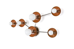 Modern celestial wall sconce in Fudge with chrome detailing and white globe bulbs, designed to resemble the Taurus constellation. A beautiful choice for earthy interiors, organic modern homes, cozy dens, hallways, and statement-making bedside lighting.