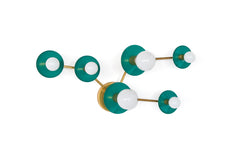 Studio product photo of the Taurus constellation wall sconce by Sazerac Stitches, shown in Mermaid Green powder-coated steel discs with warm brass arms. The sculptural star-map layout uses two larger circular discs with larger frosted globe bulbs and three smaller star discs with smaller globe bulbs, creating a modern graphic constellation pattern. Clean white background with generous negative space, ideal for searches like green wall sconce, emerald or teal bathroom lighting, brass and green sconce, mid ce