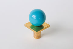 Glossy teal and brass square gumball drawer knob, ideal for colorful cabinet hardware and modern furniture upgrades. Perfect for adding a pop of color to kitchens, bathrooms, kids’ rooms, or dressers. Bold and playful hardware with a midcentury modern, whimsical design flair.