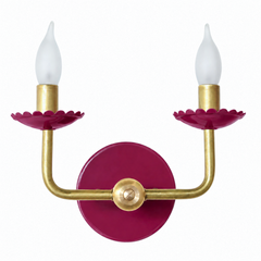 This one trades playful for sultry, a deep, wine-dark magenta on the scalloped bobeche cups and backplate that feels closer to a jewel or a velvet drape than a craft-store paint chip. The raw brass arms hold their clean, sculptural line underneath, so the shape still reads modern even as the color goes rich and moody. It has real presence, the kind of jewel-toned lighting that would suit a dark, romantic dining room, a moody library corner, or a bedroom that wants drama without going full black.