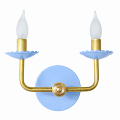 A colorful traditional wall sconce that brings a little joy to a bedroom, powder room, or hallway. The Two-Light Adele pairs a soft celestial blue powder-coated finish with warm brass arms and a scalloped, flower-shaped bobeche under each candle. Grandmillennial and sweet without tipping into cute, it's the kind of blue-and-brass fixture that reads collected and personal. Available in a range of powder-coated colors for spaces that skip the beige.