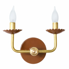 A warm chocolate brown wall sconce for the kind of room that leans rich and a little moody. The Two-Light Adele pairs a deep fudge powder-coated finish with warm brass arms and a scalloped, flower-shaped bobeche under each candle. It's a fixture with enough depth for a library, den, or bedroom, and enough charm to keep a traditional room from feeling stiff. Available in a range of powder-coated colors for homes that skip the beige.
