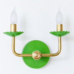 Bright, saturated, and unmistakably confident, this green skips the pastel route entirely. The scalloped bobeche cups and backplate hold a true grass-green finish over the same raw brass arms as the rest of the line, so the shape stays familiar even as the color goes bold. It suits a room that already knows it wants personality, from a bold and graphic dining room to a playroom that wants color instead of cartoon characters.