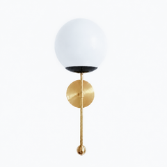 A sharp, graphic globe sconce for a powder room, bedside, or hallway that wants a wall light with real polish. The Verbena Sconce tops a round brass backplate with a slim brass stem, seats a white glass globe in a crisp black cup, and finishes the bottom with a small brass ball, the kind of detail that makes it feel custom. Black, brass, and white together read modern and timeless at once, the most graphic version of the design, striking flanking a mirror, art, or a bed. A clean, glowing light for mid-centu