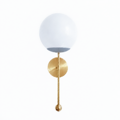 A calm gray globe sconce for a powder room, bedside, or hallway that wants a wall light with quiet, easy-to-place color. The Verbena Sconce tops a round brass backplate with a slim brass stem, seats a white glass globe in a soft gray cup, and finishes the bottom with a small brass ball, the kind of detail that makes it feel custom. Gray and brass together read neutral without going flat, at home flanking a mirror, art, or a bed, and versatile against white trim, wallpaper, tile, or a moodier wall. A soft, g