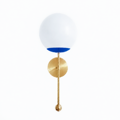 A vivid cobalt globe sconce for a powder room, bedside, or hallway that wants a wall light with real conviction. The Verbena Sconce tops a round brass backplate with a slim brass stem, seats a white glass globe in a saturated Mediterranean-blue cup, and finishes the bottom with a small brass ball, the kind of detail that makes it feel custom. This bold cobalt and brass together read confident and a little Mediterranean, striking flanking a mirror, art, or a bed, especially against white walls, tile, or warm
