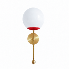 A confident true-red globe sconce for a powder room, bar, or bedside that wants a wall light with a classic pop of color. The Verbena Sconce tops a round brass backplate with a slim brass stem, seats a white glass globe in a cherry-red cup, and finishes the bottom with a small brass ball, the kind of detail that makes it feel custom. Red and brass together read playful and sexy, striking flanking a mirror, art, or a bed, especially against white walls, dark wood, or a bold wallpaper. A high-energy, glowing 