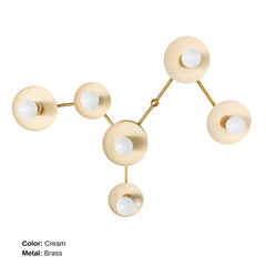 Virgo customizable six-light wall sconce shaped like the Virgo zodiac constellation, with Cream circular shades, exposed globe bulbs, and branching Brass hardware. A functional sculptural light inspired by astrology.