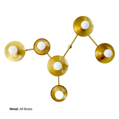 Virgo six-light sculptural wall sconce in All Brass, with warm brass circular disc shades and branching arms surrounding exposed white globe bulbs. Inspired by the Virgo zodiac constellation, the astrological light functions as statement lighting and metallic wall sculpture.