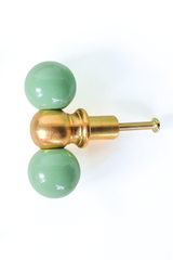 Vista green and brass double gumball knob, straight-on view with mounting screw visible. A colorful hardware pick for furniture makeovers, bathroom vanities, built-in cabinets, kitchens, kids' rooms, or offices, anywhere that needs a little personality.