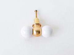 White and brass double gumball drawer pull, head-on vertical view. A classic pairing that works equally well on a dresser makeover, a bathroom vanity, kitchen cabinetry, a kid's room dresser, or an office built-in.