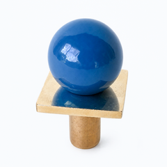 colorful and structural drawer pull features a powdercoated denim colored ball on a brass square with a small foot, making it easy to grab as well as gorgeous. Made with real brass, this knob will patina with time if you want it to. 